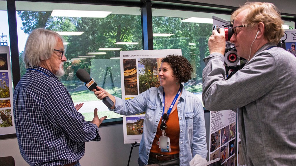 Camera crew interviews an SRS employee.