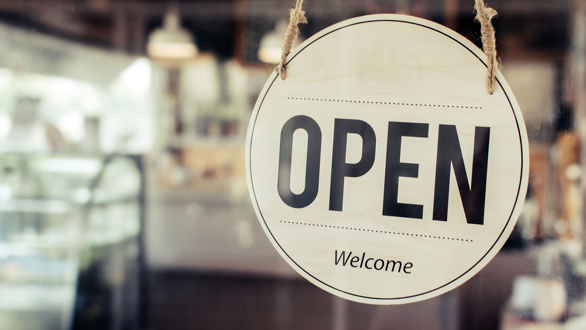 Open. coffee cafe shop text on vintage sign board hanging on glass door in modern cafe shop reopen after coronavirus quarantine is over in restaurant ready to service, small business owner concept