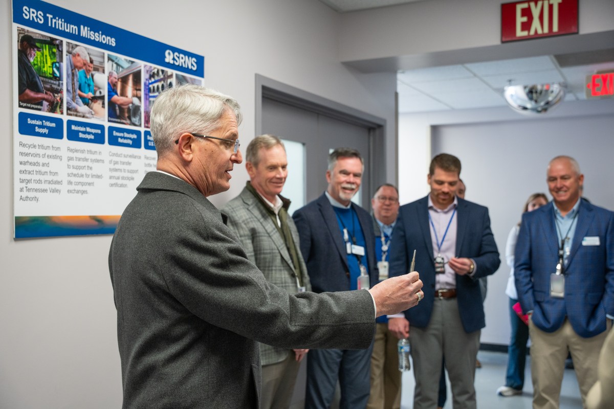 NNSA Administrator Brandon Williams holds a cut fragment of a Tritium-Producing Burnable Absorber Rod, a key component in the tritium extraction process.