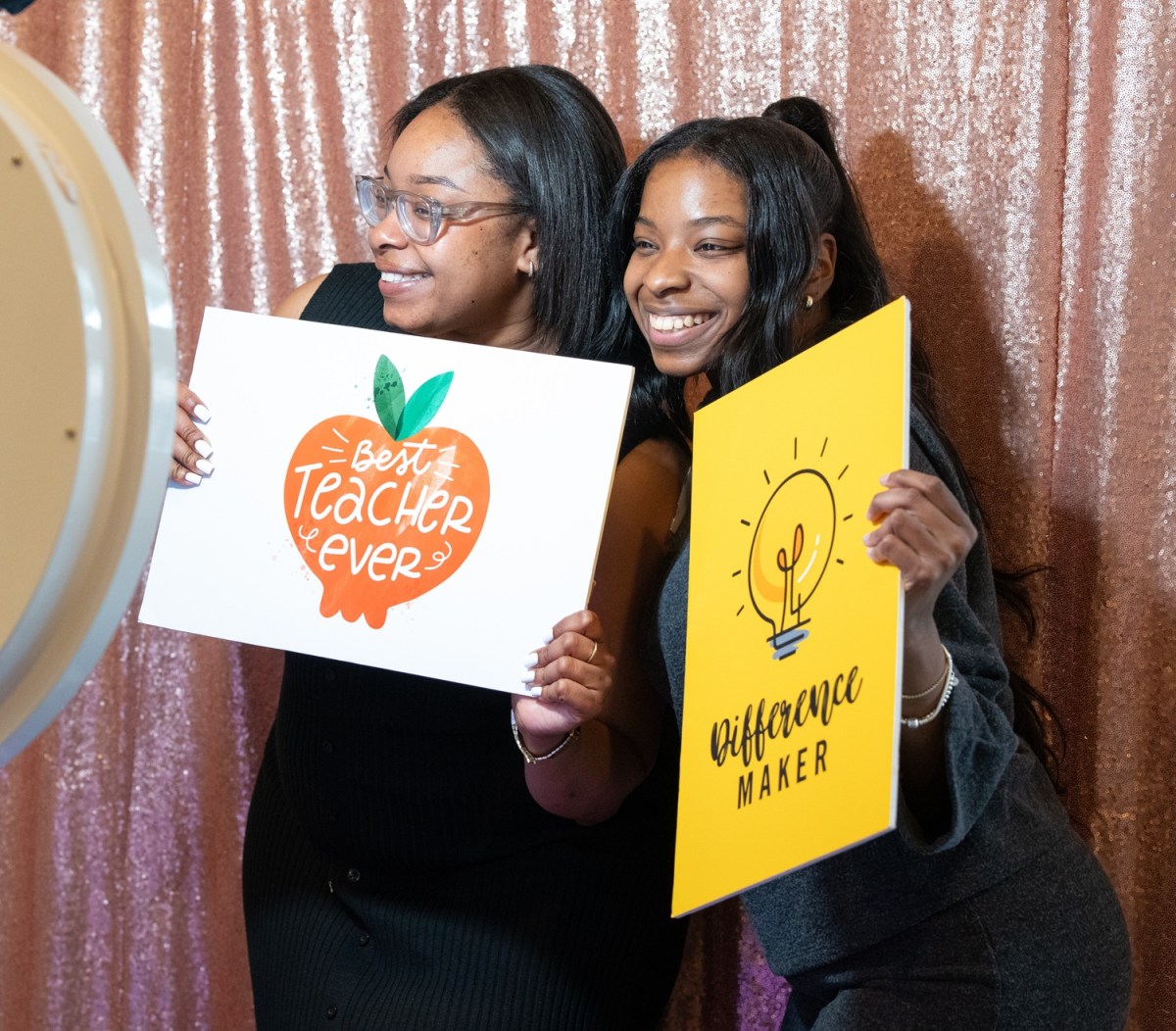 Rhapsidy Holt, an educator at C.T. Walker Traditional Magnet School, and Olivia Holt pose for a photo in the event’s photobooth.