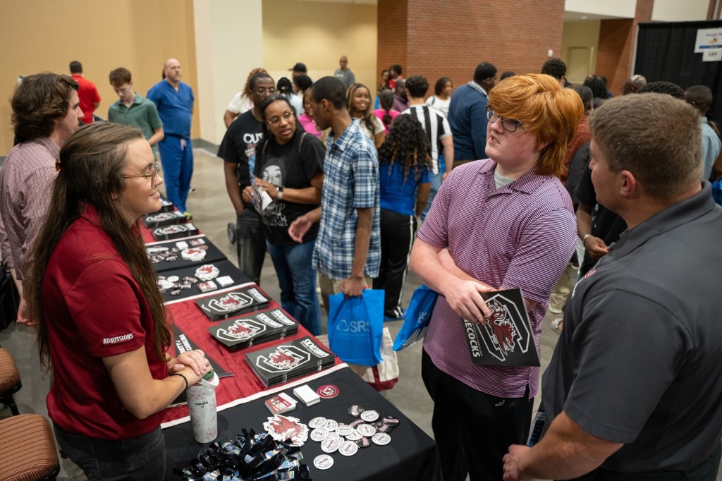 College recruiters from the University of South Carolina speak with attendees during CSRA College Night.