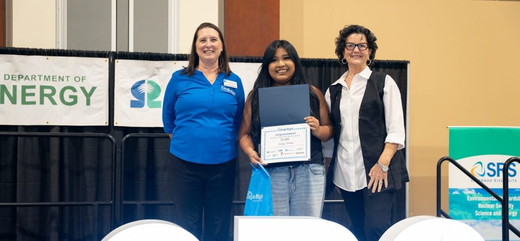 SRNS Corporate Communications Manager Lindsey MonBarren, left, and Deputy Director Barbara Smoak, right, award one of 15 ,000 scholarships to Evelyn Colohua, Burke County High School senior.
