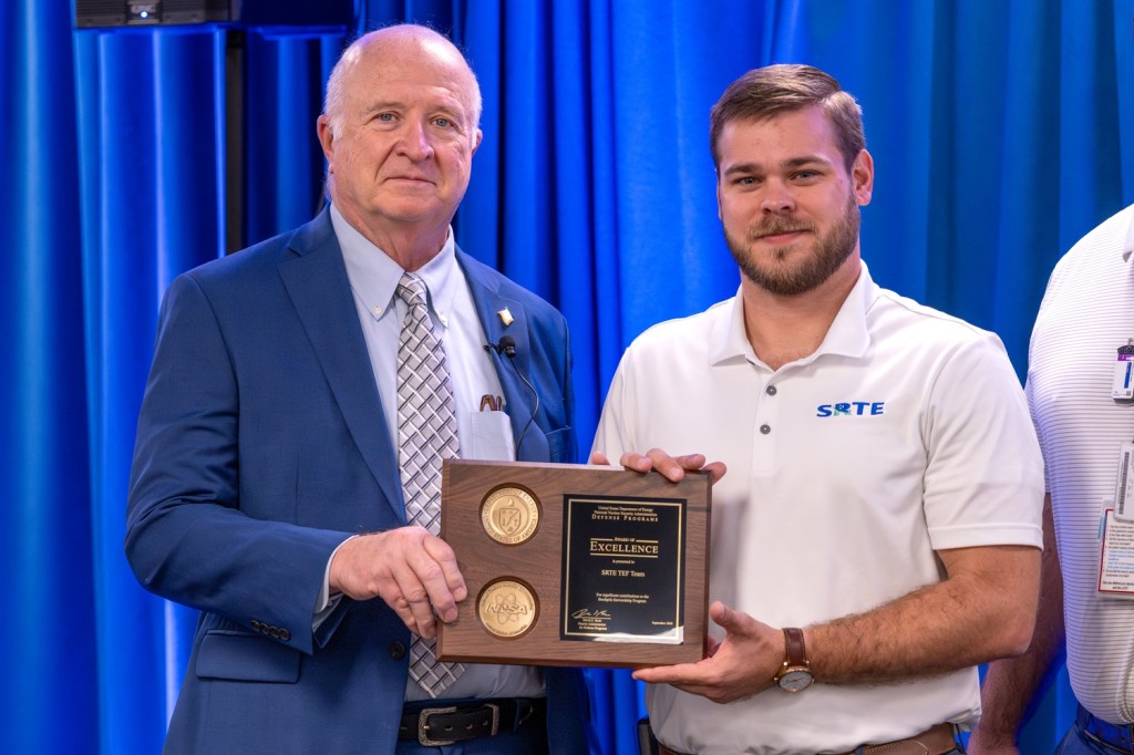 Savannah River Tritium Extraction Facility Manager Garrett Hall accepts the Defense Program Award of Excellence on behalf of the Tritium Extraction Facility team
